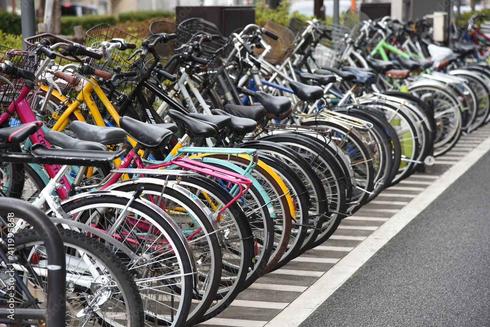 A view of the bicycle parking lot around the station in Japan. - obrazy, fototapety, plakaty 