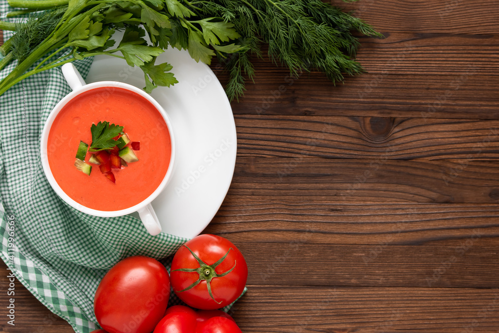 Wonderful tomato gazpacho soup with herbs and tomatoes. Top view. Copy space. Wonderful tomato gazpacho soup with herbs and tomatoes. Top view. Copy space.