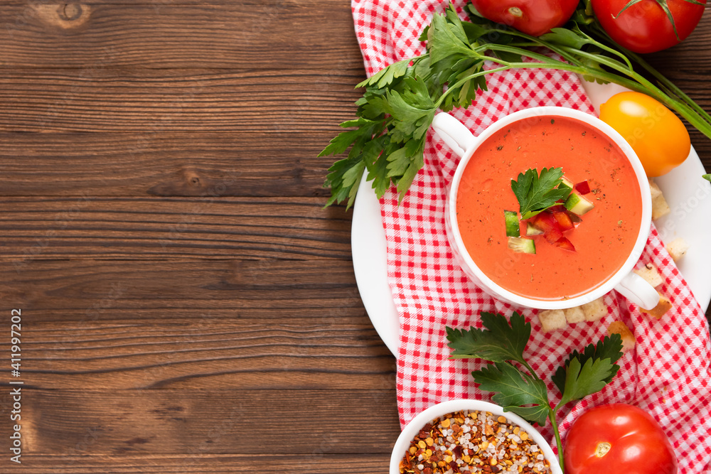 Wonderful tomato gazpacho soup with herbs and tomatoes. Top view. Copy space. Wonderful tomato gazpacho soup with herbs and tomatoes. Top view. Copy space.