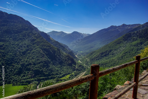 Mountain landscape in the French Pyrenees with wooden railings in the foreground