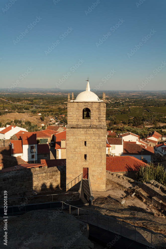 Castle bell tower with village in the background