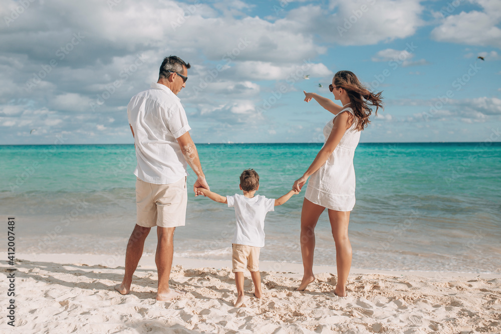 Happy family on the beach. Family vacation on the sea coast Happy family on the beach. Family vacation on the sea coast