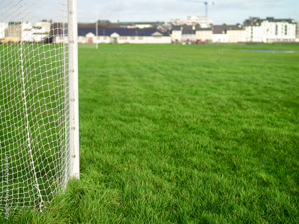 Fototapeta premium Irish sport tall goal posts in a field on a bright sunny day. Galway city, Ireland. South park. Camogie, hurling and rugby training ground. Blue cloudy sky. Selective focus