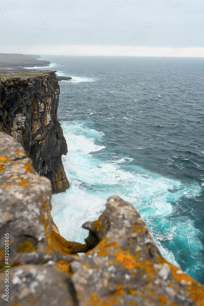 Powerful water of Atlantic ocean at the bottom of a cliff, Aran Islands, Inishmore, county Galway, Ireland.