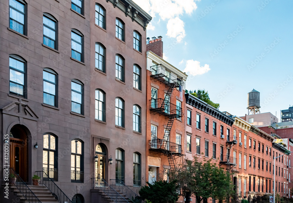 Block of historic brownstone buildings in the Chelsea neighborhood of Manhattan in New York City NYC