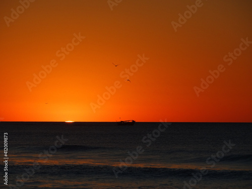sunset on the beach © Ndigiam
