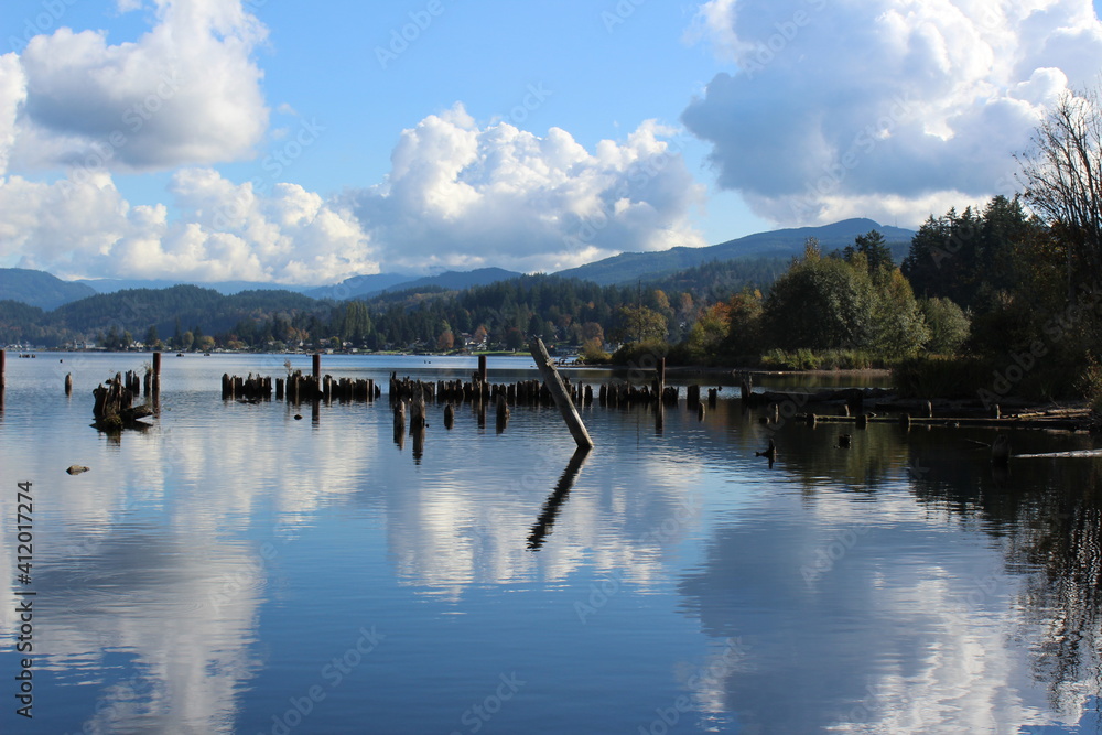 Reflection of the sky and clouds on the calm water of Lake Whatcom in fall