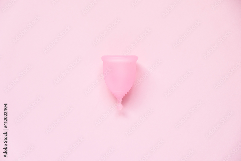 Menstrual cup on pink background. Alternative feminine hygiene product during the period. Women health concept