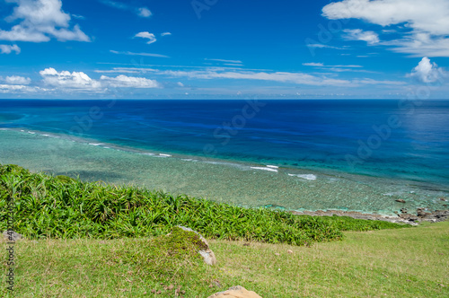 Breathtaking seascape seen from above with the beautiful clear blue waters and a beautiful coral reef contrasting with a blue sky. Yonaguni Island. photo