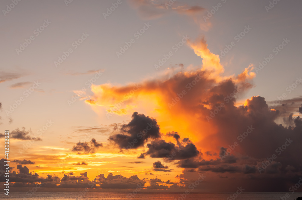 Nice Nimbus clouds illuminatted by sunset with yelloe, orange, gray colors on Yonaguni Island horizon.