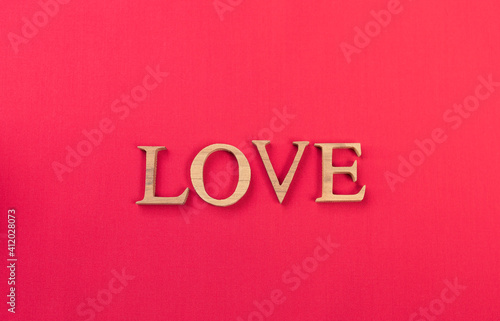 Design love wooden font on red fabric background, valentine card background idea, love and romance concept