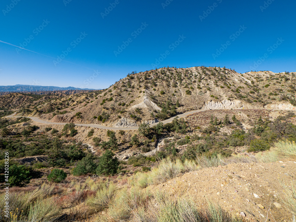 Wide angle view of California Mountain Landscape with Winding Road Daytime Wide angle view of California Mountain Landscape with Winding Road Daytime