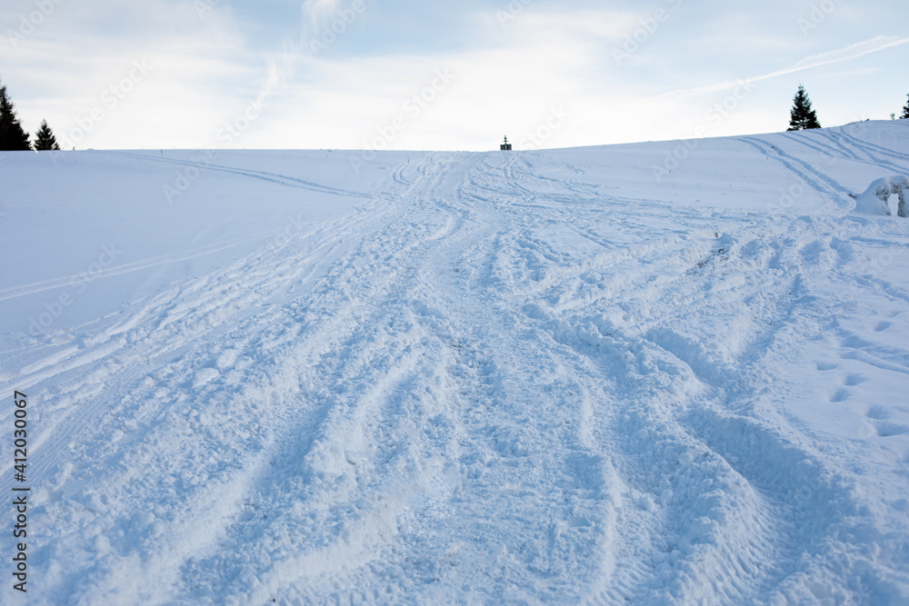 Traces in the fresh snow on the hill.Winter image. Traces in the fresh snow on the hill.Winter image.