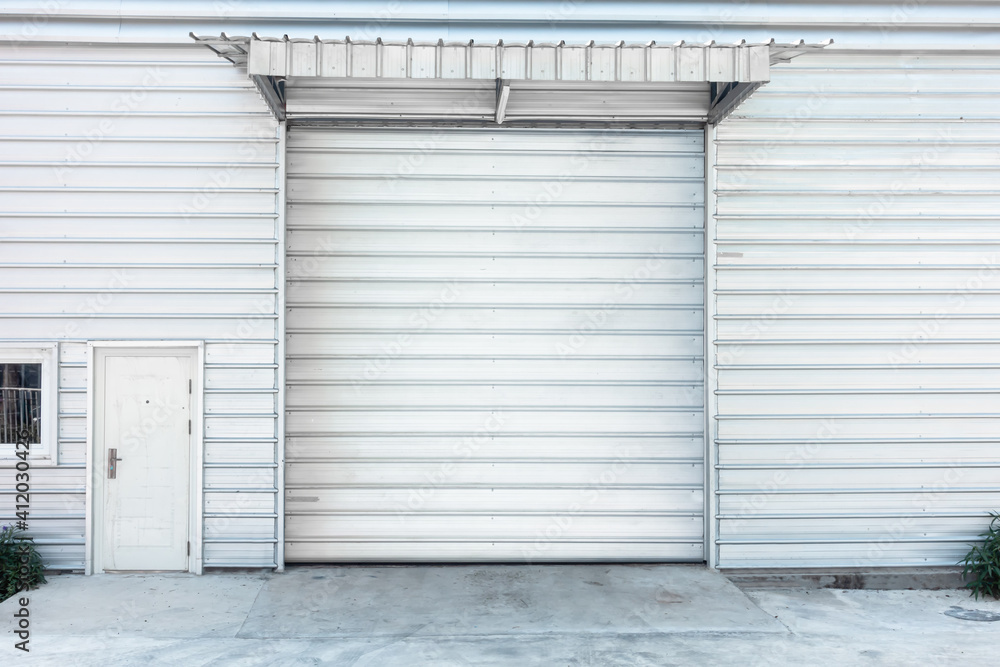 Steel Shutter Roller Door of Factory Warehouse Workshop for Materials Storage, Front View of Rolling Metal Doors for Access and Security. Gate Building Structure of Warehouses for Store Steel Shutter Roller Door of Factory Warehouse Workshop for Materials Storage, Front View of Rolling Metal Doors for Access and Security. Gate Building Structure of Warehouses for Store