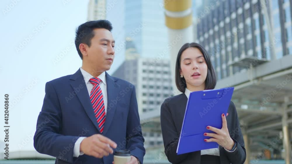 Beautiful secretary briefing her boss before meeting with partnership.
