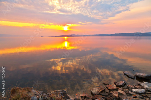 Baikal Lake in early morning of May. Beautiful landscape in bright warm colors of the rising sun over the Small Sea on shore of the Kurkut Bay. Nature background. Beautiful landscape. Spring travel