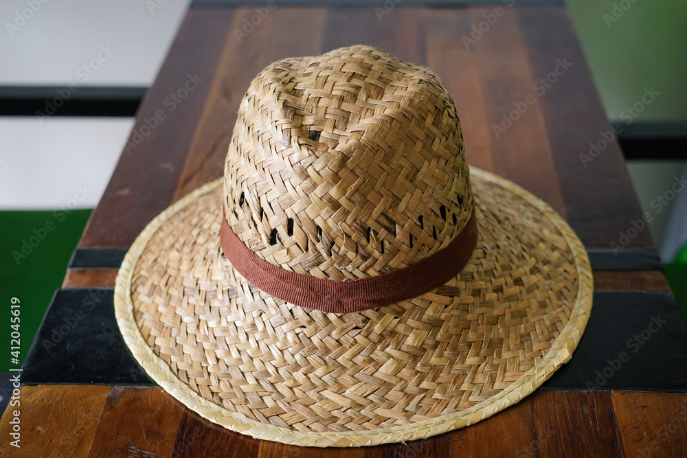 straw hat on wooden table