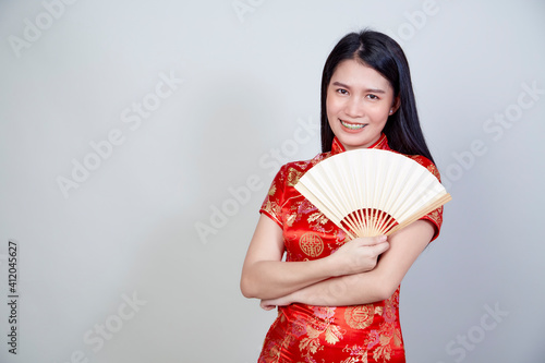 woman wearing cheongsam dress holding fan
