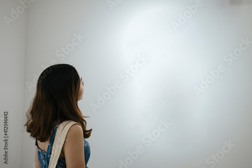 This is art. Woman sightseeing in art gallery.