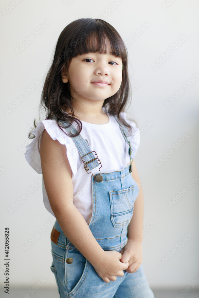 Portrait of three years cute little fair black hair Asian girl kid wearing casual cloth smiling and looking to camera with a lovely pose. Idea for a good healthy and happy adorable kid Portrait of three years cute little fair black hair Asian girl kid wearing casual cloth smiling and looking to camera with a lovely pose. Idea for a good healthy and happy adorable kid