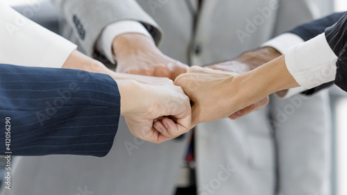 Group of business people touch the punches together, idea for unity and team work. © Bangkok Click Studio