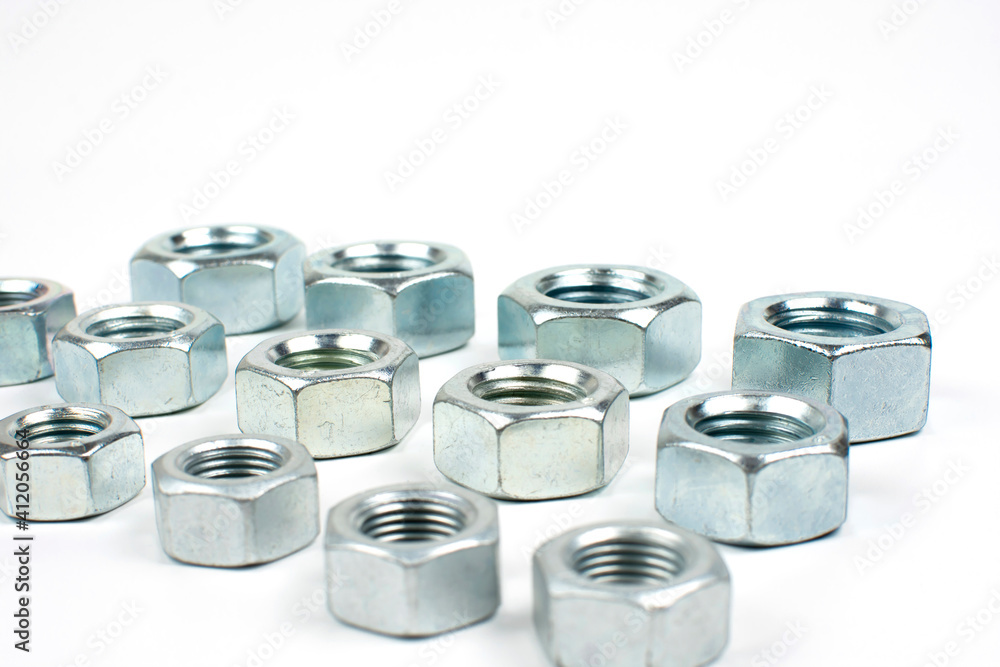 large metal nuts on a white background close up large metal nuts on a white background close up