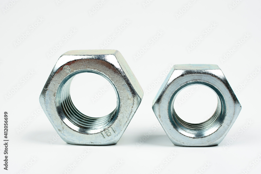 large metal nuts on a white background close up large metal nuts on a white background close up