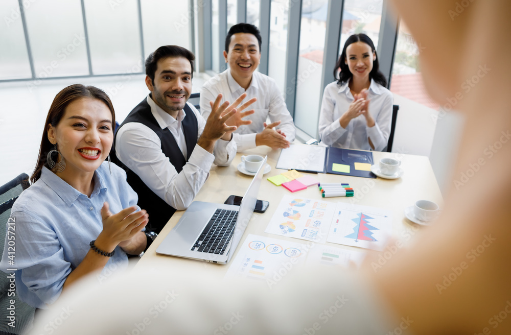 Group of four diversity businessmen, two men and three women sitting at meeting desk and pay high attention for the standing speaker. Group of four diversity businessmen, two men and three women sitting at meeting desk and pay high attention for the standing speaker.