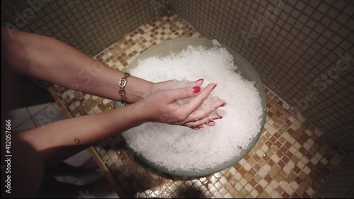 Woman spa skin treatmant with ice crystals after hot sauna. Hot and cold treatment in spa salon photo
