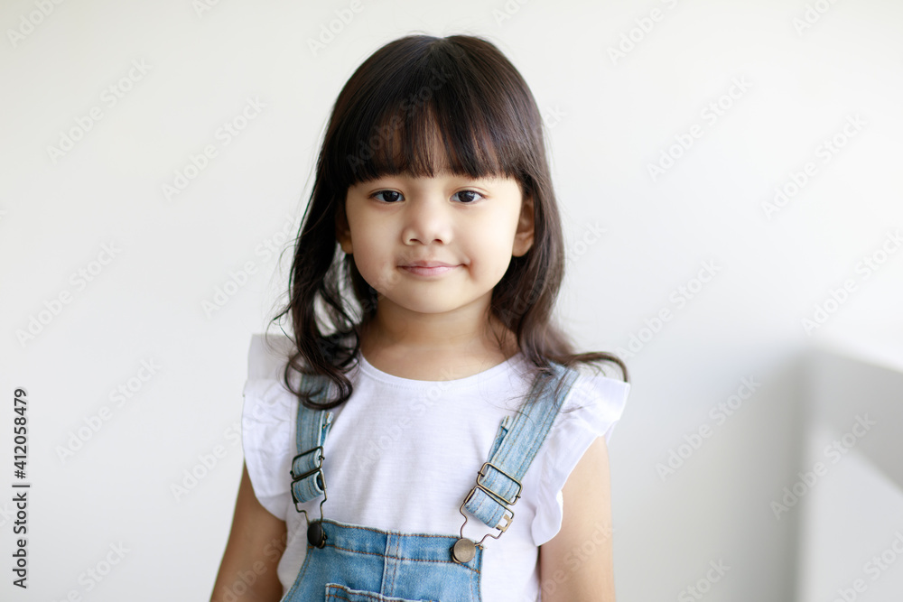 Portrait of three years cute little fair black hair Asian girl kid wearing casual cloth smiling and looking to camera with a lovely pose. Idea for a good healthy and happy adorable kid Portrait of three years cute little fair black hair Asian girl kid wearing casual cloth smiling and looking to camera with a lovely pose. Idea for a good healthy and happy adorable kid
