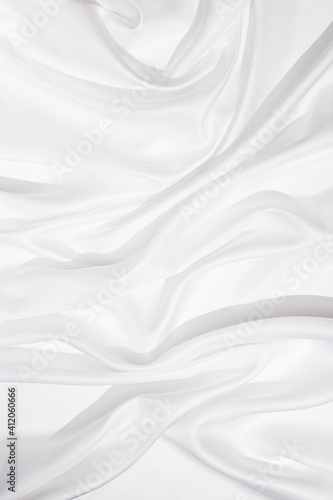 Texture of white silk cloth, textile background, drapery and pleats on delicate fabric.