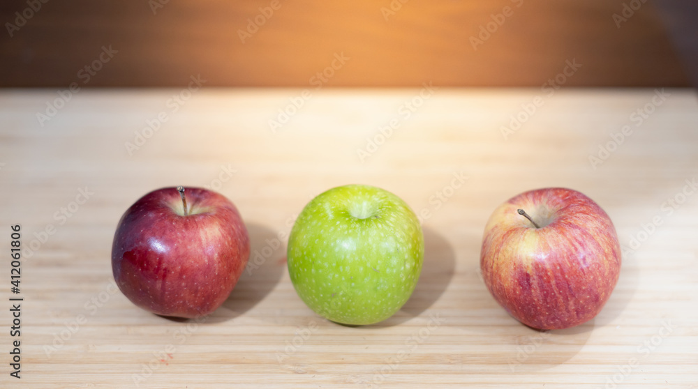Several of color apples on the cutting wood board, Place for text. Several of color apples on the cutting wood board, Place for text.