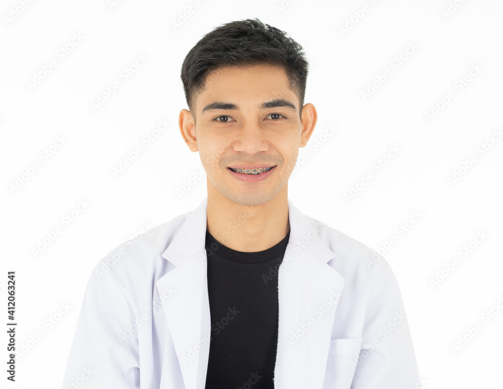 A young and handsome Asian teen man smiling to show the good tooth with brace. Isolated on white background A young and handsome Asian teen man smiling to show the good tooth with brace. Isolated on white background