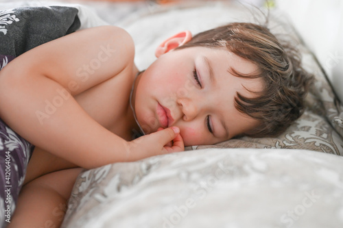 Close up portrait of little boy sleeping in bed. Happy bedtime concept