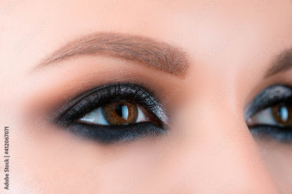 Obraz premium Closeup smoky makeup eye dark eyelids. Female eyes with beautiful bright fashion style.