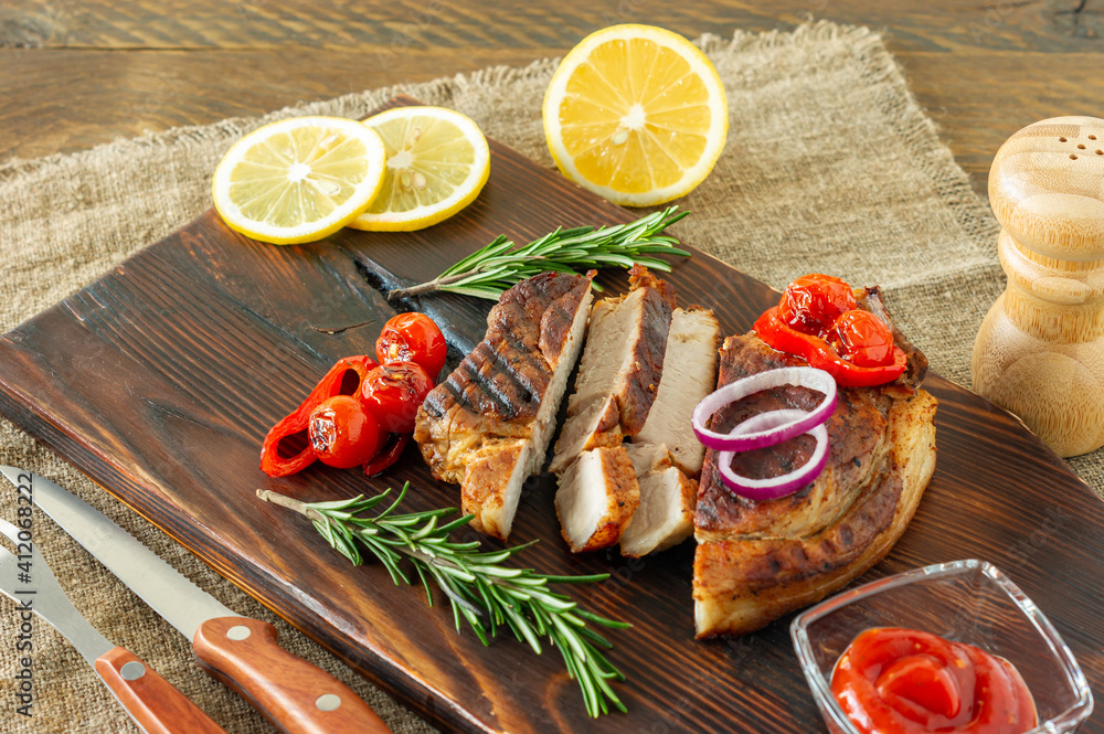Fresh juicy roasted red meat on wooden board, with spices and vegetables. Restaurant food, delicious dish Fresh juicy roasted red meat on wooden board, with spices and vegetables. Restaurant food, delicious dish
