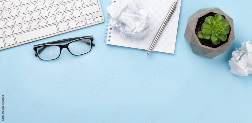 Office desk with supplies, plant and blank notepad Office desk with supplies, plant and blank notepad