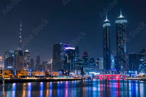 Amazing Dubai City Skyline at Night or Blue Hour. View from Dubai water canal business bay  United Arab Emirates.