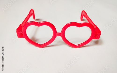 The front view of the children's toy heart-shaped glasses on a white background