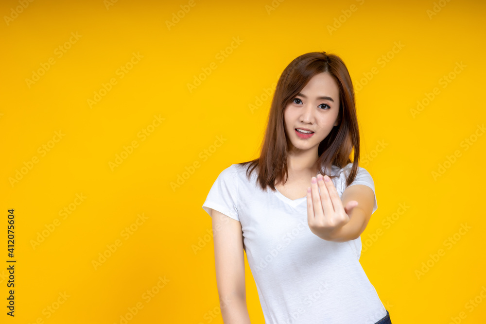 Young elegant Asian woman smiling and showing thumb up copy space isolated on yellow background Young elegant Asian woman smiling and showing thumb up copy space isolated on yellow background