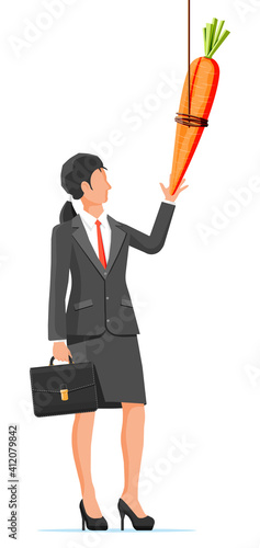 Carrot on a stick and businesswoman. Motivation, stimulus, incentive and reaching goal concept metaphor. Fishing wooden stick with hanging carrot