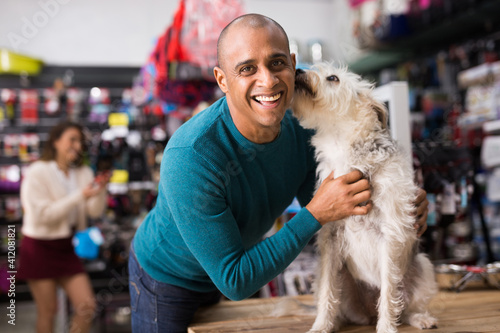 Portrait of happy man with beloved dog in pet shop