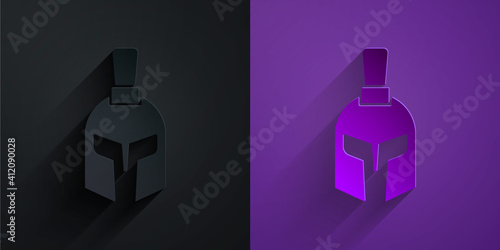 Paper cut Greek helmet icon isolated on black on purple background. Antiques helmet for head protection soldiers with a crest of feathers or horsehair. Paper art style. Vector.