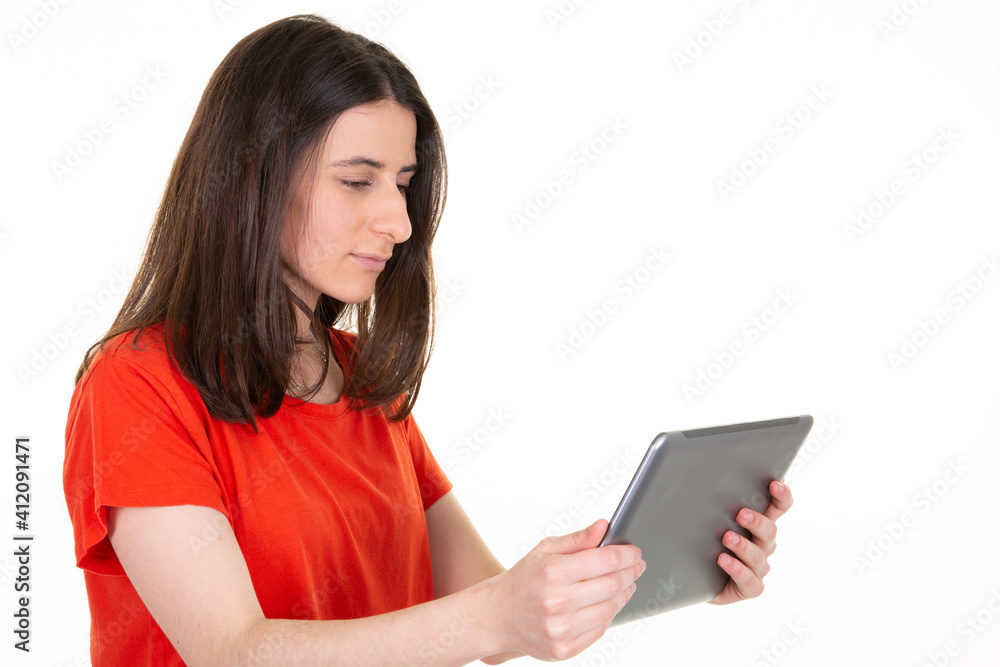 Cute young beautiful woman profile side portrait holding tablet on white background Cute young beautiful woman profile side portrait holding tablet on white background