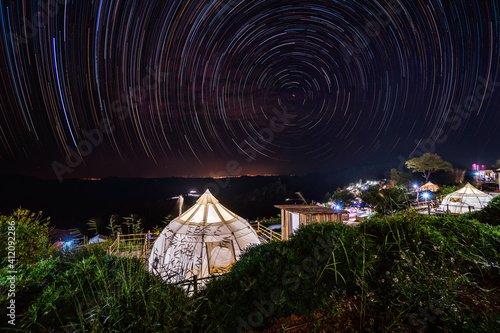 Night sky star trail over the Dome tents in resort on Mon Keing Dao at north of Thailand. © Natnan