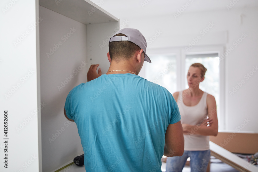 Husband and wife assembling new furniture - renovation home concept. Husband and wife assembling new furniture - renovation home concept.