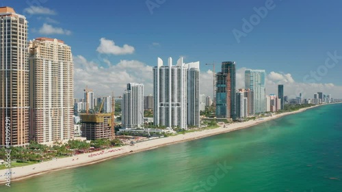 Scenic Miami skyline. Beautiful modern cityscape, aerial drone water footage. Cinematic white tall design buildings at the beach with ocean view apartment. USA travel background. Florida vacation 4K.