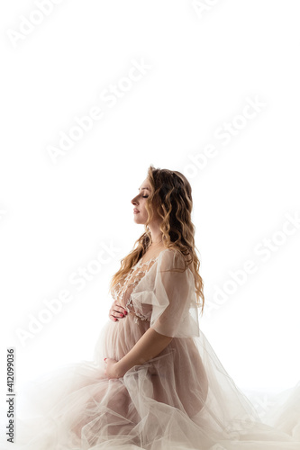 Pregnant girl on a light background
