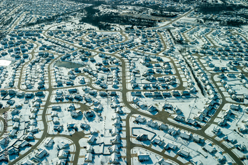 Aerial view of snow covered suburban neighborhood.