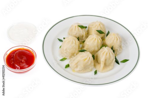 Boiled hot khinkali with meat, spices and ketchup.